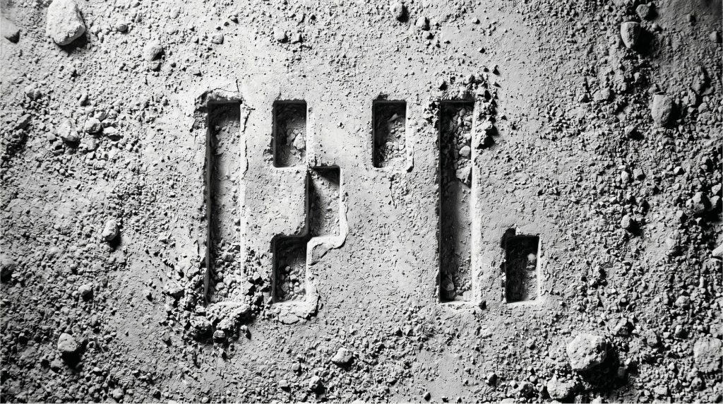 Weathered logo imprint left behind after a rebrand